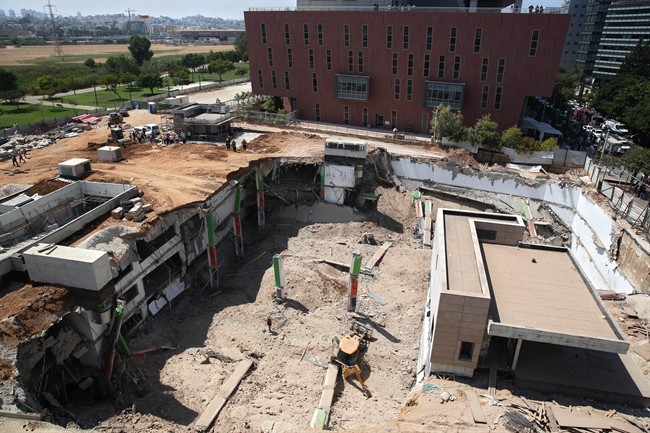 A general view of the scene of a building collapse in Tel Aviv, Monday, Sept. 5, 2016. The building collapsed in a Tel Aviv construction zone on Monday, injuring at least 18 people and trapping three people inside, according to police and media reports.