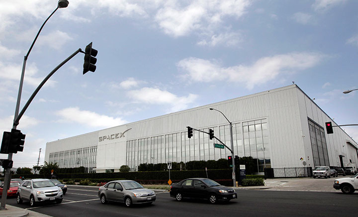 Motorists drive by SpaceX headquarters in Hawthorne, Calif., Friday, May 25, 2012.