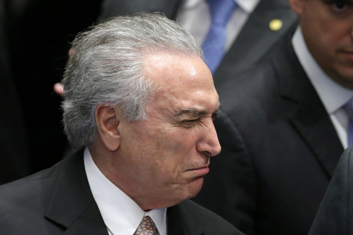 Brazil's President Michel Temer winks after taking the presidential oath at the National Congress, in Brasilia, Brazil, Wednesday, Aug. 31, 2016. Temer was sworn in as Brazil's new leader following the ouster of President Dilma Rousseff.
