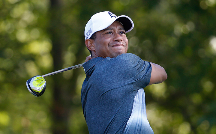 In this July 31, 2015 file photo, Tiger Woods watches his tee shot on the 13th hole during the second round of the Quicken Loans National golf tournament, in Gainesville, Va. 