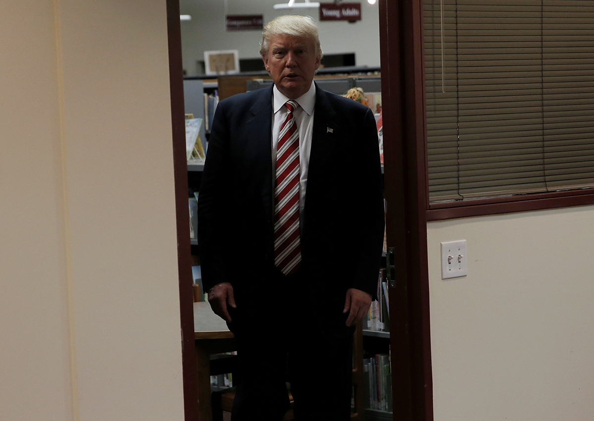 Republican presidential nominee Donald Trump stands in a doorway ahead of round table meeting on child care issues before speaking at a campaign event in Aston, Pennsylvania, U.S., September 13, 2016. 