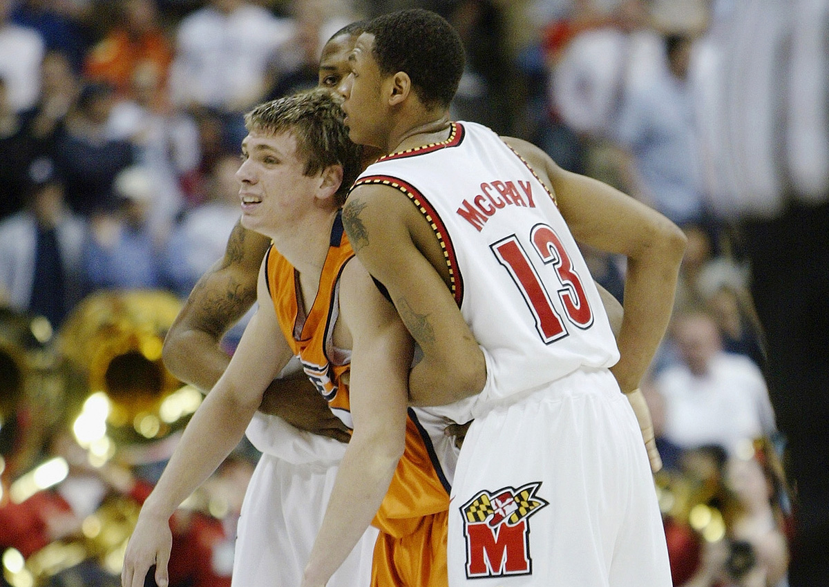 Chris McCray and John Gilchrist of the Maryland Terrapins help up Chris Craig of the University of Texas El Paso Miners after their first round game of the NCAA Division I Men’s Basketball Tournament at Pepsi Center on March 18, 2004.