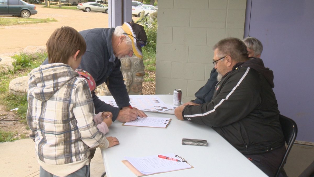 Members of Friends of Wakamow gather signatures on their petition to restore provincial funding for the park. 