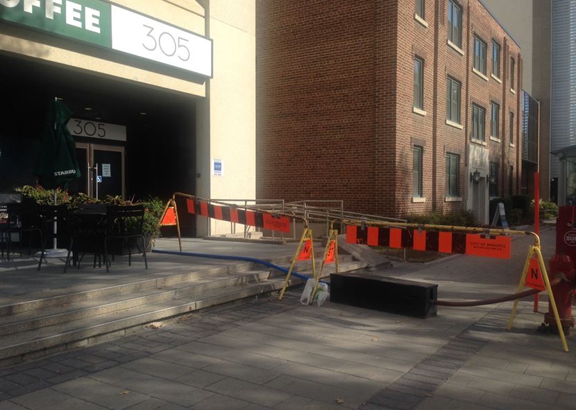 Repairs taking over the sidewalk on 305 Broadway.