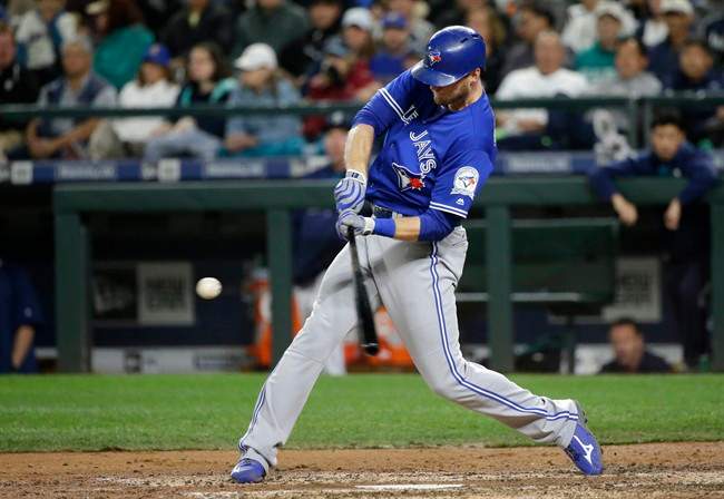 Toronto Blue Jays' Michael Saunders hits a two-run home run in the fourth inning of a baseball game, Tuesday, Sept. 20, 2016, in Seattle. Blue Jays' Troy Tulowitzki scored on the play.