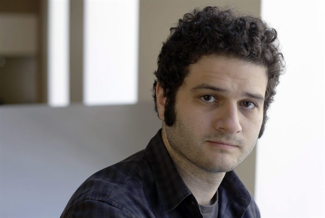 In this April 26, 2012 file photo, Dustin Moskovitz, a Facebook co-founder, poses outside of his office in San Francisco. Moskovitz says he is giving $20 million to help defeat Donald Trump, calling the Republican presidential candidate divisive and dangerous and his appeals to Americans who feel left behind "quite possibly a deliberate con.".