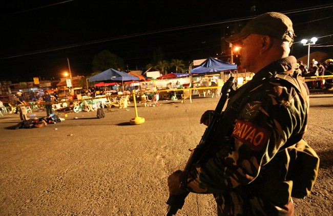 A Philippine soldier keeps watch at a blast site at a night market that has left several people dead and wounded others in southern Davao city, Philippines late Friday Sept. 2, 2016. The powerful explosion in Philippine President Rodrigo Duterte's hometown in the southern Philippines took place amid a security alert due to a major offensive against Abu Sayyaf militants in the region, officials said. 