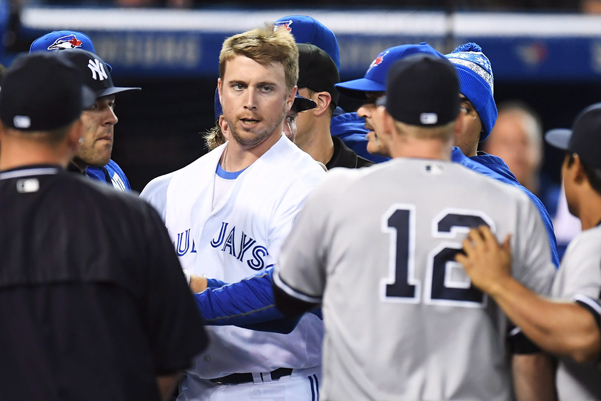 Toronto Blue Jays' Justin Smoak eyes down New York Yankees Chase Headley (12) during a bench-clearing melee.