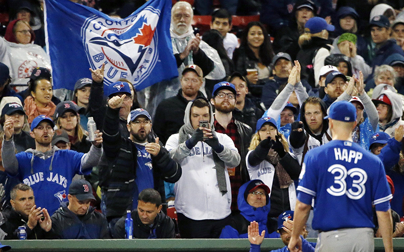 Fans cheer as Toronto Blue Jays' J.A. Happ leaves the field after being relieved during the seventh inning of a baseball game against the Boston Red Sox in Boston, Saturday, Oct. 1, 2016. 