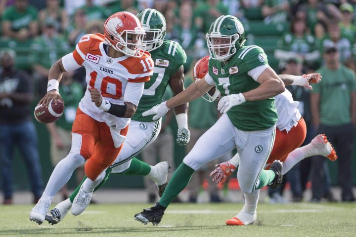 B.C. Lions quarterback Jonathon Jennings (#10) takes off with the ball under pressure from Saskatchewan Roughriders defensive lineman Justin Capicciotti (#7) during first half CFL action in Regina on Saturday, July 16, 2016.