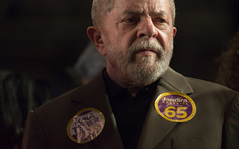 Brazil's former President Luiz Inacio Lula da Silva listens as Rio de Janeiro mayoral candidate Jandira Feghali speaks during a rally in Rio de Janeiro, Brazil. 