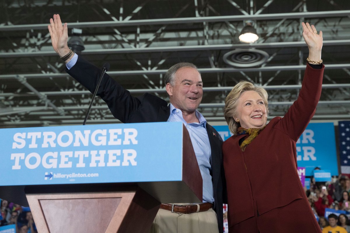 Democratic presidential nominee Hillary Clinton and her running mate Sen. Tim Kaine, D-Va., wave at supporters during a campaign event at the Taylor Allderdice High School, Saturday, Oct. 22, 2016, in Pittsburgh. 
