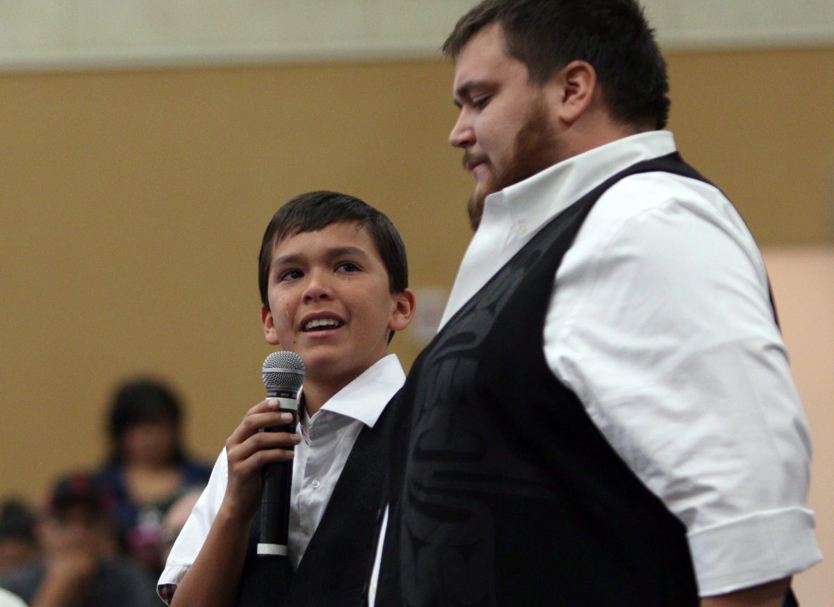 Hjalmer Wenstob listens to Ucluelet Secondary Gr. 8 student Tim Masso, 13, as he sheds tears as he talks about teaching First Nations' language to his fellow classmates and about segregation at his school to Carolyn Bennett, Minister of Indigenous and Northern Affairs, at the Assembly of First Nations' annual general meeting at the Songhees Wellness Centre in Victoria, B.C. Monday, October 24, 2016. THE CANADIAN PRESS/Chad Hipolito.