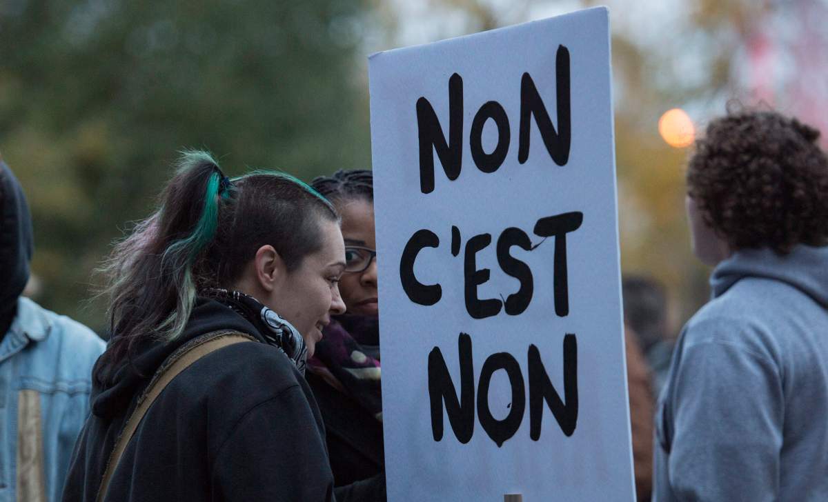 A demonstrator holds a sign during a march against rape culture on Wednesday, October 26, 2016 in Montreal.