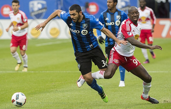Montreal Impact's Victor Cabrera, left, challenges New York Red Bulls' Bradley Wright-Phillips during first half action of the first leg of the eastern conference MLS soccer semifinal in Montreal, Sunday, Oct. 30, 2016. 