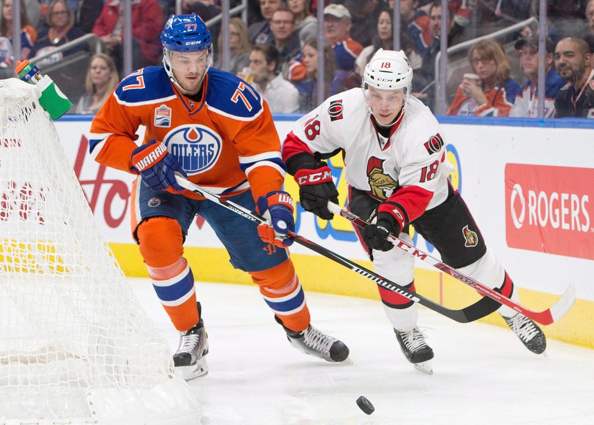 Ottawa Senators' Ryan Dzingel (18) and Edmonton Oilers' Oscar Klefbom (77) battle for the puck during first period NHL action in Edmonton, Alta., on Sunday October 30, 2016. 