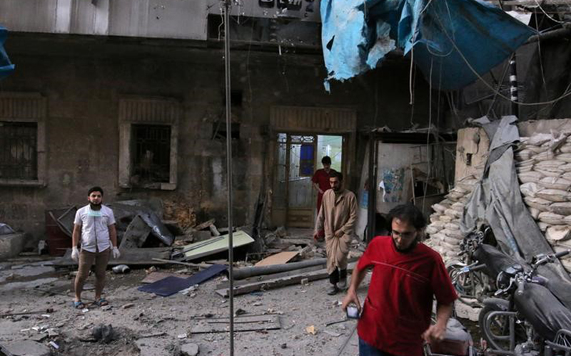 Medics inspect the damage outside a field hospital after an airstrike in the rebel-held al-Maadi neighbourhood of Aleppo, Syria, September 28, 2016. 