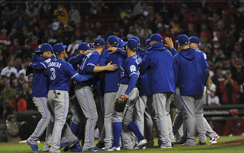 The Toronto Blue Jays celebrate their victory over the Boston Red Sox at Fenway Park. 
