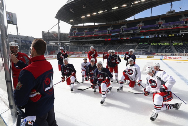 Winnipeg Jets assistant coach Jamie Kompon instructs players during the practice for the 2016 Tim Hortons NHL Heritage Classic.