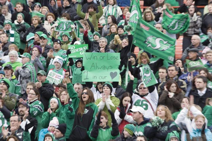 Saskatchewan Roughriders fans hold up a signs in a crowd of cheering fans at Mosaic Stadium that welcomed back their team from Calgary on Monday, Nov. 30, 2009 in Regina, Sask. The Saskatchewan Roughrider lost to the Montreal Alouettes in Sunday's Grey Cup game in Calgary.