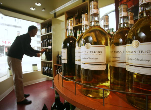 Vincor brands Jackson-Triggs wines are displayed at a Wine Rack store in Toronto, Ontario, on Monday, April 3, 2006, as a store employee arranges wine bottles.  (Photo by Norm Betts/Bloomberg via Getty Images).
