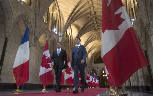 Canadian Prime Minister Justin Trudeau and French Prime Minister Manuel Valls walk through the Hall of Honour on Parliament Hill in Ottawa, Thursday October 13, 2016..