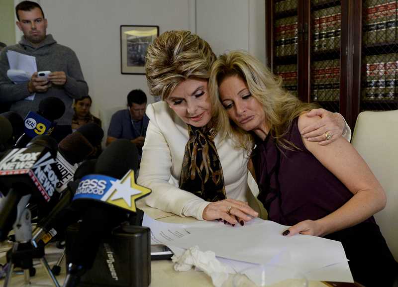 Summer Zervos, a former contestant on the TV show The Apprentice, is embraced by lawyer Gloria Allred (L) while speaking about allegations of sexual misconduct against Donald Trump during a news conference in Los Angeles, California, U.S. October 14, 2016. REUTERS/Kevork Djansezian