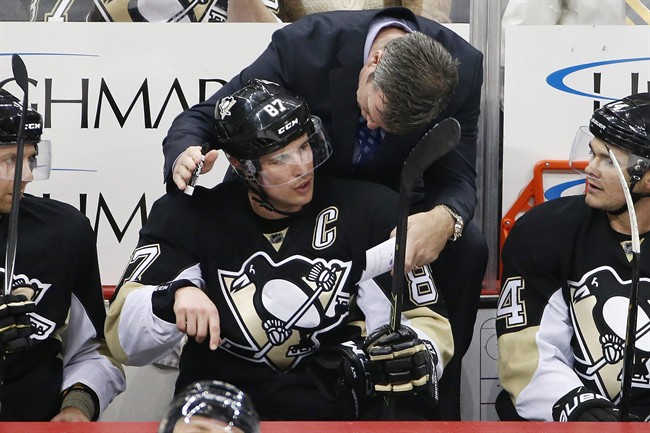 In this Feb. 2, 2016, file photo, Pittsburgh Penguins' Sidney Crosby (87) talks with head coach Mike Sullivan during an NHL hockey game against the Ottawa Senators in Pittsburgh. Pittsburgh Penguins superstar Sidney Crosby has been diagnosed with another concussion and there is no timetable for his return.