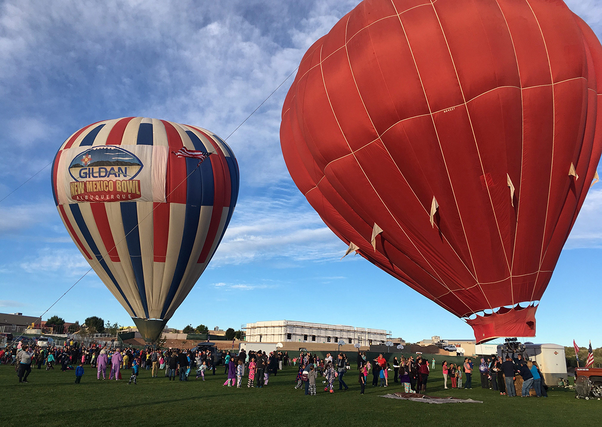 Two hot air balloons inflate at Vista Grande Elementary School in Rio Rancho, N.M. on Friday, Sept. 30, 2016, as part of the Albuquerque Aloft program that lifts balloons on school grounds as part of the 45th Albuquerque International Balloon Fiesta. 