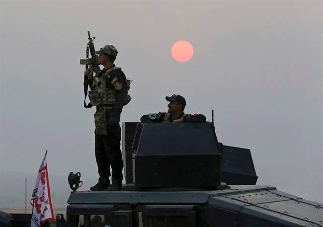 Iraq's elite counterterrorism forces advance toward Islamic State positions as fighting to retake the extremist-held city of Mosul enters its second week, in the village of Tob Zawa, outside Mosul, Monday, Oct. 24, 2016.