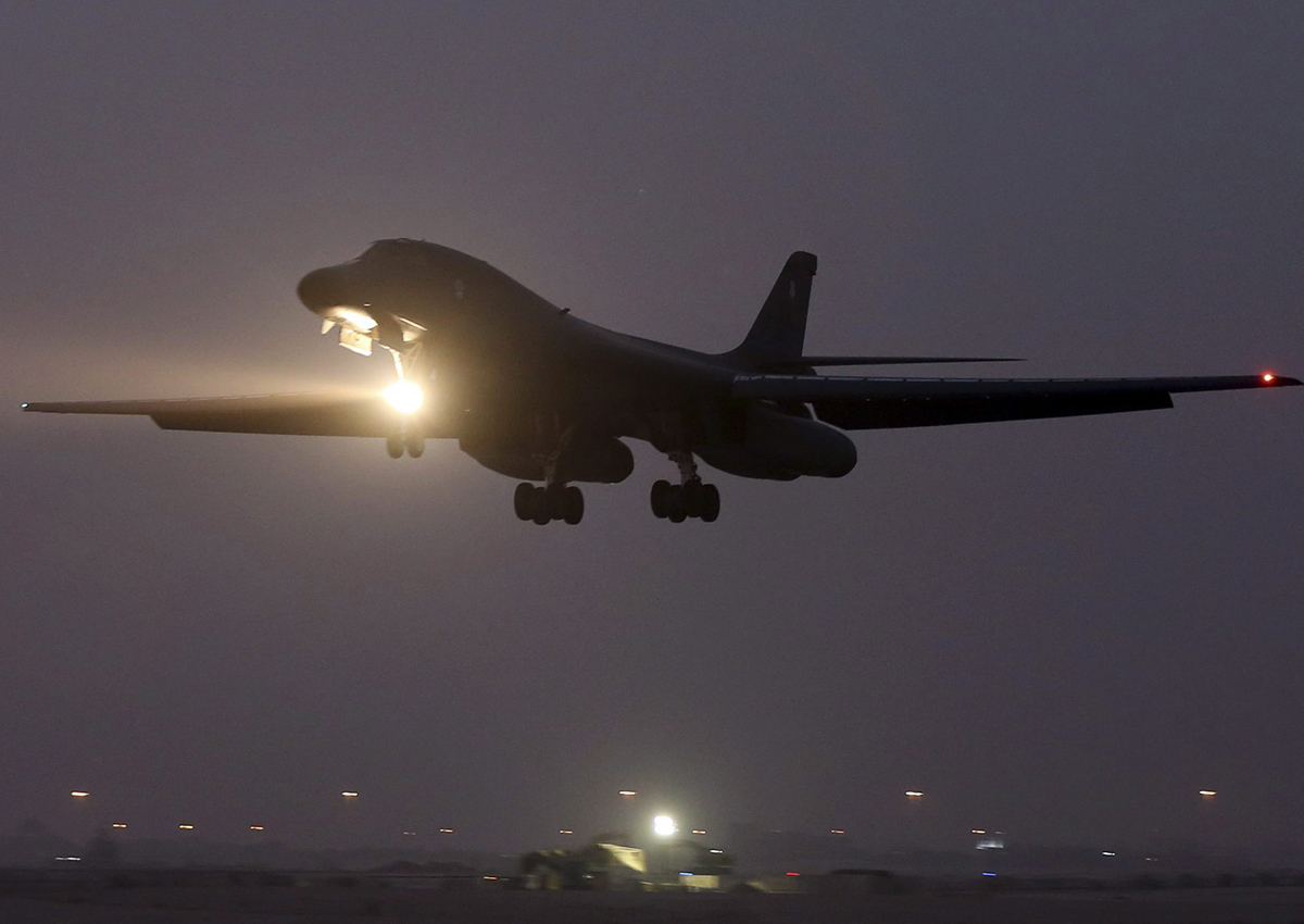 In this photo taken Monday, March 9, 2015, a B-1 bomber prepares to land after finishing a mission at the al-Udeid Air Base in Doha, Qatar. 