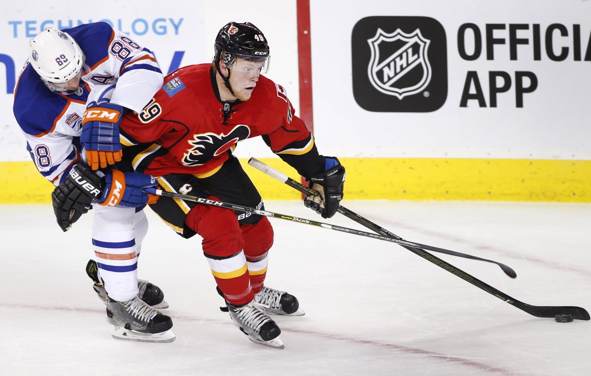 NHL profile photo on Calgary Flames' Hunter Shinkaruk, right, playing against Edmonton Oilers' Brandon Davidson at an NHL game in Calgary, Alberta on Sept. 26, 2016. THE CANADIAN PRESS IMAGES/Larry MacDougal.