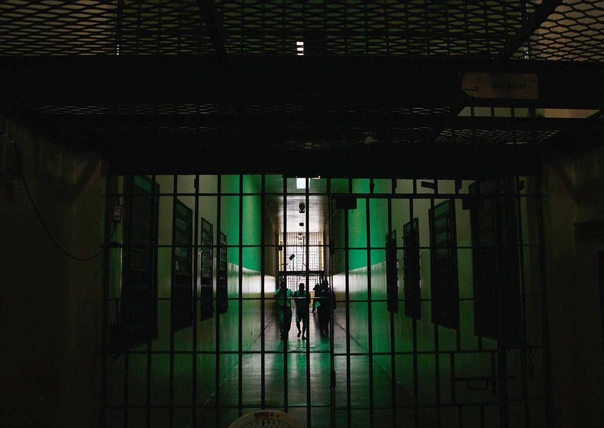 An inmate is escorted through a prison in Brazil on February 18, 2016. 