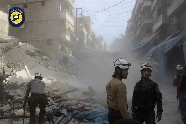 In this picture provided by the Syrian Civil Defense group known as the White Helmets, Syrian Civil Defense workers search through the rubble in rebel-held eastern Aleppo, Syria, Wednesday, Oct. 12, 2016. A spectacular air raid in Syria‚Äôs besieged rebel-held Aleppo city hit the territory‚Äôs biggest market Wednesday, killing at least 15, obliterating several stores and levelling buildings, activists and a witness said. The raid came a day after at least 41 people dead, including at least five children, were killed when aircraft bombed several neighborhoods in the eastern Aleppo area, overwhelming rescue workers who continued a day later Wednesday to search for survivors under the rubble.