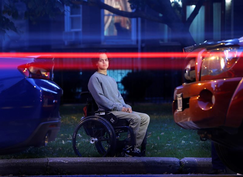 In this Thursday, Oct. 13, 2016 photo, vehicles pass by as Jonathan Annicks poses for a portrait in front of his home, just a few feet from where a gunman shot him while he was inside his brother's parked car in Chicago on April 10. 
