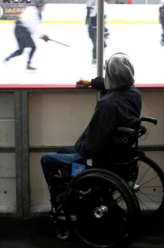 In this Sunday, Aug. 28, 2016 photo, Jonathan Annicks watches his brother’s ice hockey team play in a recreational league game in Romeoville, Ill.