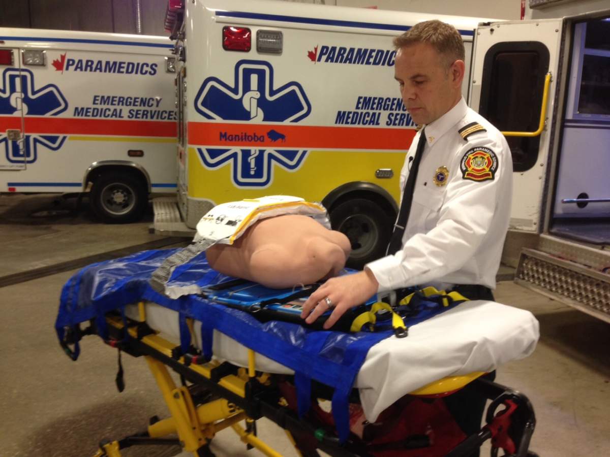Chris Cauthers with the Winnipeg Fire and Paramedic Service demonstrates the CPR device. 