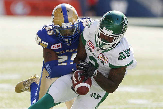 Winnipeg Blue Bombers' Bruce Johnson (25) strips the ball from the hands of Saskatchewan Roughriders' Ricky Collins Jr. (3) during first half CFL Banjo Bowl action, in Winnipeg on September 10, 2016.