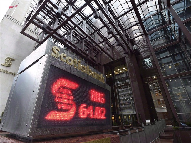 An electronic sign posting financial data is shown outside the Scotiabank building in Toronto Thursday, April 9, 2015.