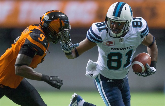Tori Gurley, right, fights off B.C. Lions' Brandon Stewart after making a reception during the second half of a CFL game in Vancouver, B.C., on Thursday July 7, 2016. 