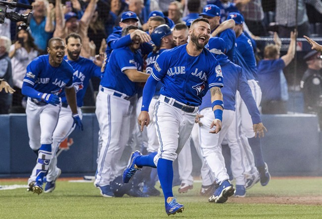 Toronto Blue Jays' Kevin Pillar and his team celebrate their walk-off win to eliminate the Texas Rangers during the tenth inning to win the American League Division Series in Toronto on Sunday, October 9, 2016.