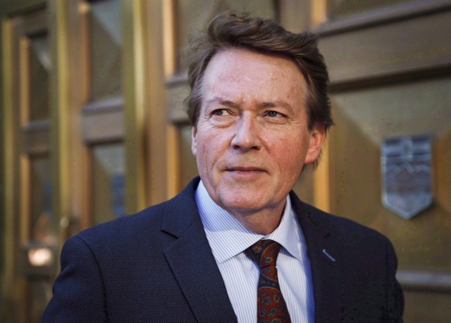 Former TV journalist Arthur Kent outside court during a break in his lawsuit against Postmedia and other individuals related to a 2008 column, in Calgary, Alta., on Nov. 16, 2015. Kent wants a judge to award him $1.2 million for his legal costs in a defamation lawsuit against Canada's largest newspaper chain.