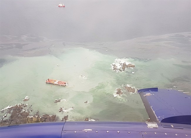 A tug boat that ran aground near British Columbia's Great Bear Rainforest is seen on Thursday, Oct. 13, 2016 in this aerial handout photo. A tug boat that ran aground and sank near British Columbia's Great Bear Rainforest is leaking diesel fuel, which the coast guard says is expected to dissipate.