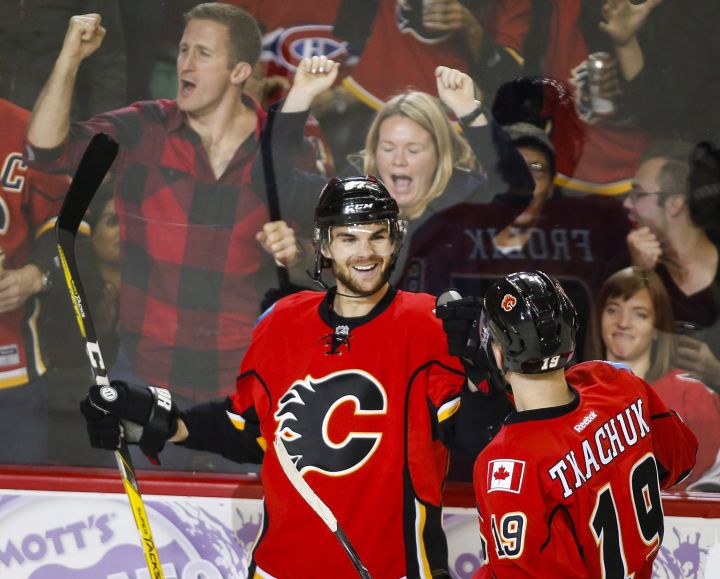 Calgary Flames' Michael Frolik, left, from the Czech Republic, celebrates his goal with teammate Matthew Tkachuk during third period NHL hockey action against the Ottawa Senators in Calgary, Friday, Oct. 28, 2016.