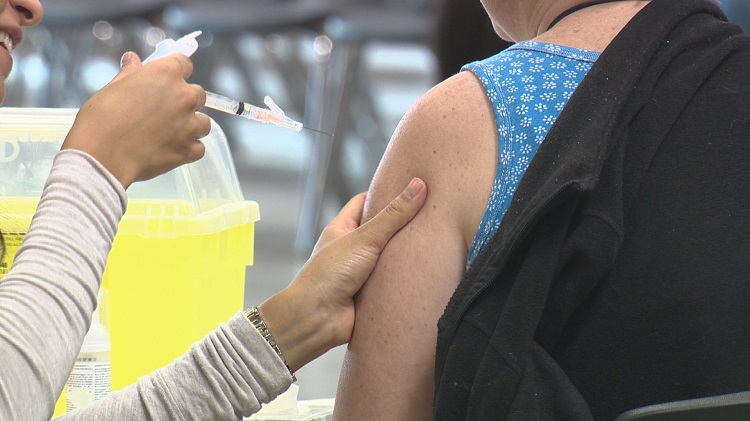 A woman gets a free flu shot at an open clinic in Lethbridge, Alta. 