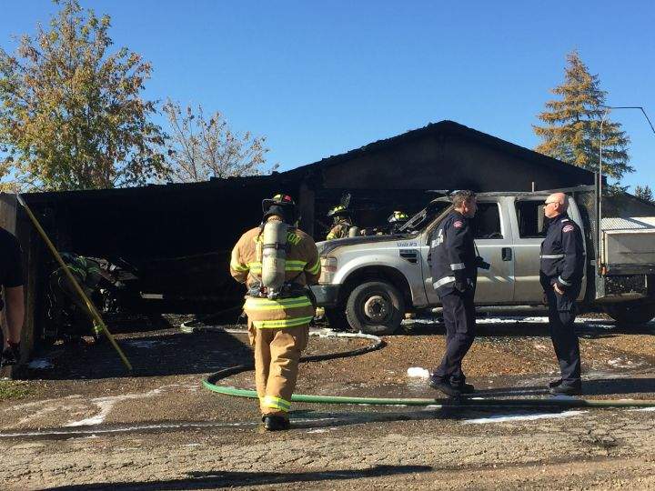 Fire crews are seen in the area of 66 Street and 149 Avenue after a garage caught fire in northeast Edmonton on Oct. 2, 2016.