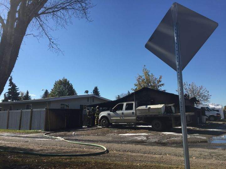 Fire crews are seen in the area of 66 Street and 149 Avenue after a garage caught fire in northeast Edmonton on Oct. 2, 2016.