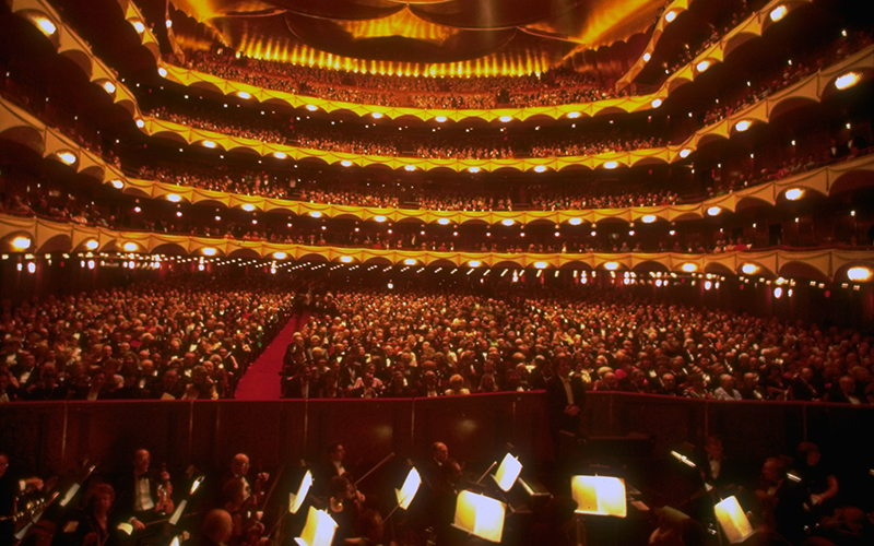 Interior view, overlooking the orchestra pit, of a capacity crowd for a performance at the Metropolitan Opera House.