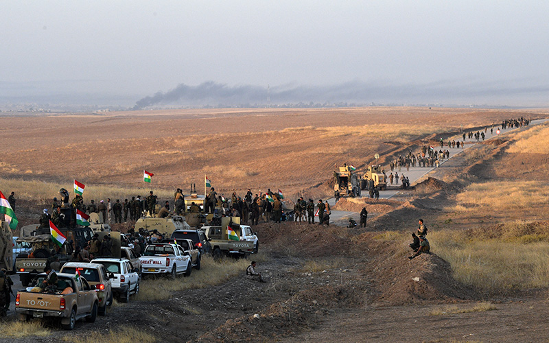 Kurdish peshmerga forces move forward from an assembly point as they prepare to begin an assault to recapture the village of Tiskharab from ISIS on October 20, 2016 near Mosul, Iraq.