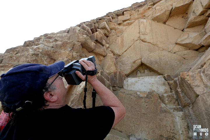 A researcher from the team of scientists using infrared to scan an exposed chevron.